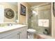Clean bathroom featuring a shower with glass door, neutral tile, and a modern sink at 2182 Corinne S Ct # C, St Petersburg, FL 33712