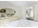 Bright bedroom featuring a large dresser with mirror, and a comfortable bed with white flower accents at 2182 Corinne S Ct # C, St Petersburg, FL 33712