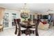 Formal dining room featuring a chandelier, large table, and access to the outdoors at 2182 Corinne S Ct # C, St Petersburg, FL 33712