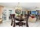 Formal dining room featuring a chandelier, large table, and access to the outdoors at 2182 Corinne S Ct # C, St Petersburg, FL 33712