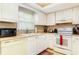Bright kitchen featuring white cabinetry, laminate countertops, and modern appliances at 2182 Corinne S Ct # C, St Petersburg, FL 33712