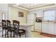 Eat-in kitchen with breakfast bar, white appliances, and laminate countertops at 2182 Corinne S Ct # C, St Petersburg, FL 33712