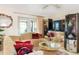 Comfortable living room with patio access, tile flooring, and modern entertainment setup at 2182 Corinne S Ct # C, St Petersburg, FL 33712