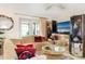 Comfortable living room with patio access, tile flooring, and modern entertainment setup at 2182 Corinne S Ct # C, St Petersburg, FL 33712