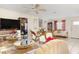 Spacious living room with tile flooring, ornate furnishings, and a large television at 2182 Corinne S Ct # C, St Petersburg, FL 33712