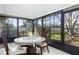 Enclosed sunroom with a mosaic table and views of the landscaped backyard at 2182 Corinne S Ct # C, St Petersburg, FL 33712