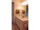 Bright bathroom featuring a white vanity with a countertop sink and a decorative towel rack at 2221 Norwegian Dr # 43, Clearwater, FL 33763