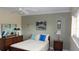 A serene bedroom with a combination of modern and vintage furniture, a ceiling fan, and abundant natural light at 2221 Norwegian Dr # 43, Clearwater, FL 33763