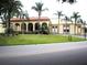 Exterior view of community center with arched walkways, manicured lawns, and palm trees, offering a picturesque gathering space at 2221 Norwegian Dr # 43, Clearwater, FL 33763