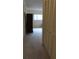 Hallway with a window at the end and closet doors to the right at 2221 Norwegian Dr # 43, Clearwater, FL 33763