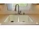 The kitchen sink features a double basin, neutral counters, and a modern faucet at 2221 Norwegian Dr # 43, Clearwater, FL 33763