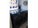 Laundry room features front loading Samsung washer and dryer and decorative shelving at 2221 Norwegian Dr # 43, Clearwater, FL 33763
