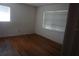 Simple bedroom with wood floors and two bright windows at 2335 Murilla S Way, St Petersburg, FL 33712