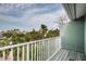 Balcony view showing lush greenery and tropical palm trees, showcasing the outdoor scenery and peaceful surroundings at 2515 Bay Blvd # A, Indian Rocks Beach, FL 33785