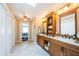 Spacious bathroom featuring a double vanity, wood cabinets, tile floors, and access to the bedroom at 2515 Bay Blvd # A, Indian Rocks Beach, FL 33785