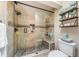 Elegant bathroom featuring a glass shower enclosure, stone accents, a built-in shower bench, and modern fixtures at 2515 Bay Blvd # A, Indian Rocks Beach, FL 33785