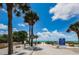 Pathway to Indian Rocks Beach with signage and tropical palm trees at 2515 Bay Blvd # A, Indian Rocks Beach, FL 33785