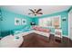 Bright bedroom featuring two twin beds, ceiling fan, and a charming coastal design at 2515 Bay Blvd # A, Indian Rocks Beach, FL 33785