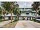Inviting two-story condo with driveways, garages, and mature palm trees at 2515 Bay Blvd # A, Indian Rocks Beach, FL 33785