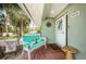 Charming front porch with brick floor, seating, and delightful decor at 2515 Bay Blvd # A, Indian Rocks Beach, FL 33785