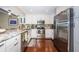 Modern kitchen with stainless steel appliances, white cabinets, and granite countertops at 2515 Bay Blvd # A, Indian Rocks Beach, FL 33785