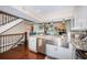 Bright kitchen with granite counters, stainless appliances, a farmhouse sink, and an open view to the living room at 2515 Bay Blvd # A, Indian Rocks Beach, FL 33785