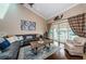 Comfortable living room with high ceilings, a leather sofa, and balcony access at 2515 Bay Blvd # A, Indian Rocks Beach, FL 33785