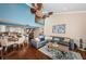 Open-concept living room with dark wood floors and an adjacent kitchen and staircase at 2515 Bay Blvd # A, Indian Rocks Beach, FL 33785