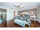 Inviting main bedroom with a decorative ceiling fan, hardwood floors, and a wood accent wall, perfect for relaxation at 2515 Bay Blvd # A, Indian Rocks Beach, FL 33785