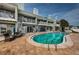Exterior shot of a sparkling pool surrounded by private balconies and patios with spiral staircases at 2515 Bay Blvd # A, Indian Rocks Beach, FL 33785