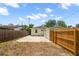 Fenced backyard showcasing a concrete patio area, lush greenery, and a detached garage at 2585 9Th N Ave, St Petersburg, FL 33713