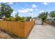 Spacious driveway and backyard area enclosed by a wooden fence, leading to a detached garage at 2585 9Th N Ave, St Petersburg, FL 33713