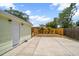 Spacious backyard featuring a concrete patio, wooden fence, and back access door at 2585 9Th N Ave, St Petersburg, FL 33713