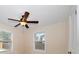 Bedroom showcasing two windows, a ceiling fan, and neutral walls, offering natural light and comfort at 2585 9Th N Ave, St Petersburg, FL 33713