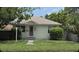 Charming single-story home featuring mature trees, a well-maintained lawn, and a welcoming front entrance at 2585 9Th N Ave, St Petersburg, FL 33713