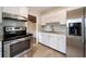 Updated kitchen showcasing stainless steel appliances, white cabinets, and light countertops at 2585 9Th N Ave, St Petersburg, FL 33713