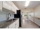 Modern kitchen with stainless steel appliances, light blue backsplash, and light countertops at 2585 9Th N Ave, St Petersburg, FL 33713