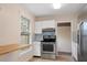 Bright kitchen featuring stainless steel appliances, updated cabinets, and a breakfast nook at 2585 9Th N Ave, St Petersburg, FL 33713