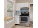 Updated kitchen showcasing stainless steel range, white cabinets, and a view to the breakfast nook at 2585 9Th N Ave, St Petersburg, FL 33713