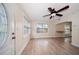 Inviting living area with wood-look flooring, ceiling fan, and natural light from large windows at 2585 9Th N Ave, St Petersburg, FL 33713