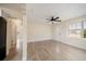 Spacious living area featuring a ceiling fan, light-colored walls, and luxury vinyl plank flooring at 2585 9Th N Ave, St Petersburg, FL 33713