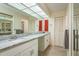 Bathroom featuring marble countertop, neutral tile flooring, and bright overhead skylight at 2636 Enterprise E Rd # C24, Clearwater, FL 33759