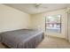 Bedroom with neutral carpet, ceiling fan, a crib, and a view of the community at 2636 Enterprise E Rd # C24, Clearwater, FL 33759