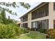 Well maintained exterior featuring a screened balcony, patio, and lush landscaping at 2636 Enterprise E Rd # C24, Clearwater, FL 33759
