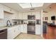 Charming kitchen with white cabinets, stainless steel appliances, and modern fixtures at 2636 Enterprise E Rd # C24, Clearwater, FL 33759