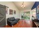 A living room with modern lighting, hardwood floors, and a balcony for enjoying outdoor views at 2636 Enterprise E Rd # C24, Clearwater, FL 33759