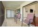 Relaxing screened patio with comfortable seating and view to the interior through the sliding door at 2636 Enterprise E Rd # C24, Clearwater, FL 33759