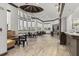 Community room with large windows, coffered ceilings, and seating areas with booths and tables at 27447 Water Ash Dr, Wesley Chapel, FL 33544