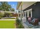 A relaxing backyard with an awning-covered dining area, artificial turf and ample seating at 2807 N Morgan St, Tampa, FL 33602