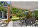 Exterior backyard view showing patio area and dining table with shade, complemented by lush landscaping at 2807 N Morgan St, Tampa, FL 33602